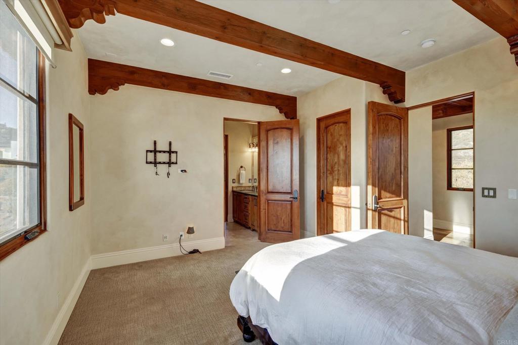 18179 El Brazo Rancho Santa Fe, CA 92067 - Photo 42 of 69 a bedroom with a bed and a large mirror
