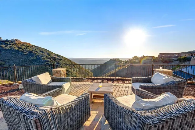 a front view of a house with a yard and mountain