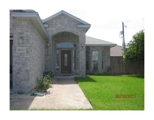 a view of a brick house with a yard