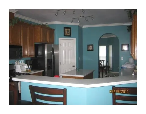 a kitchen with a sink and refrigerator