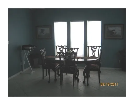 a view of a dining room with furniture and window