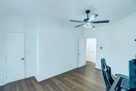 a view of a workspace with wooden floor