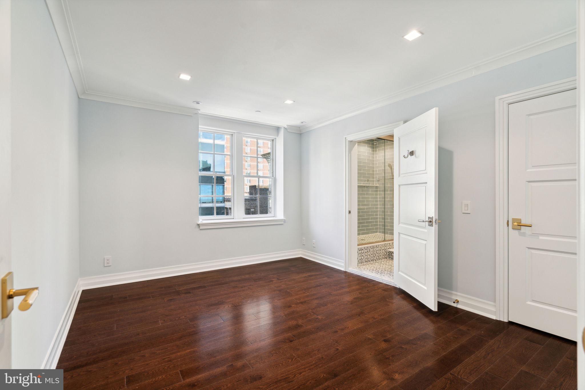 1601 Locust Street, Unit 1300 Philadelphia, PA 19102 - Photo 33 of 45 an empty room with wooden floor and windows