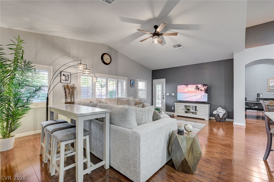 1604 Cattle Ranch Place Henderson, NV 89002 - Photo 24 of 99 Hardwood floors and vaulted ceilings create an inviting atmosphere in this open-concept living area.
