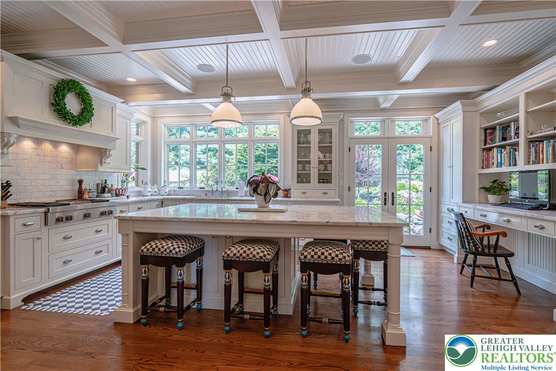 1825 Sherwood Road Allentown, PA 18103 - Photo 20 of 67 a kitchen with stainless steel appliances granite countertop a table chairs and wooden floor