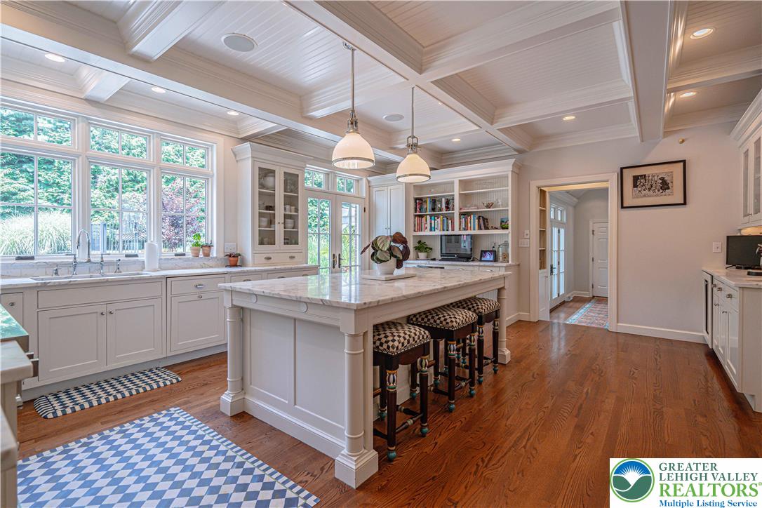 1825 Sherwood Road Allentown, PA 18103 - Photo 22 of 67 a kitchen with stainless steel appliances granite countertop a stove a sink dishwasher and cabinets with wooden floor