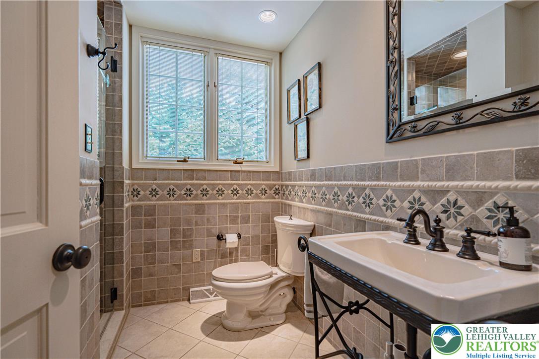 1825 Sherwood Road Allentown, PA 18103 - Photo 34 of 67 a bathroom with a sink a toilet and a mirror