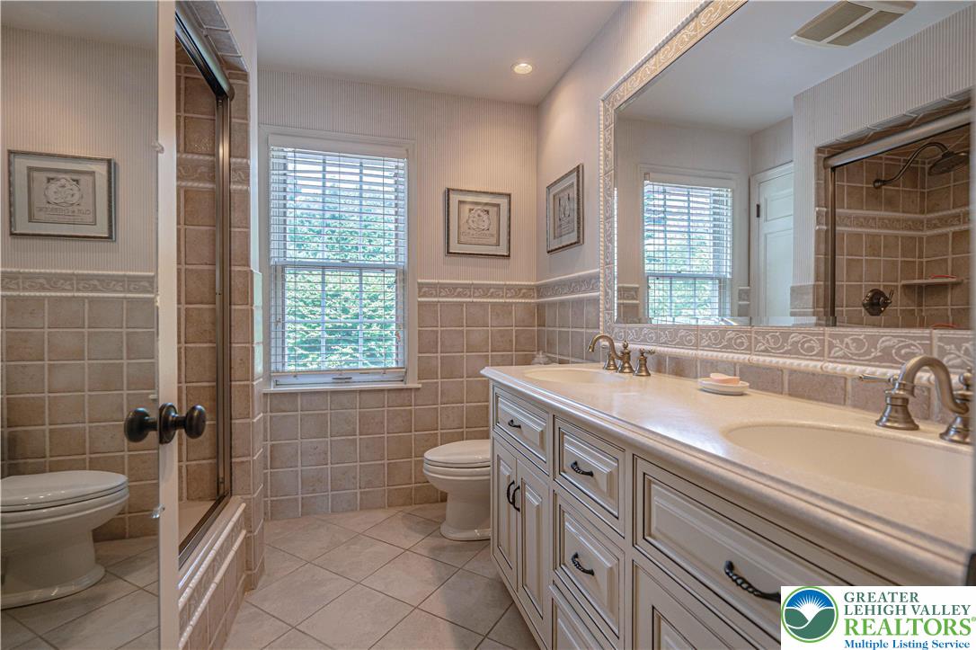 1825 Sherwood Road Allentown, PA 18103 - Photo 47 of 67 a bathroom with a double vanity sink toilet and shower
