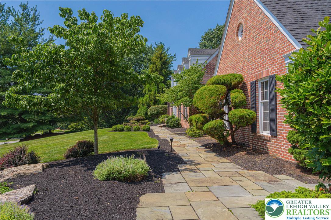 1825 Sherwood Road Allentown, PA 18103 - Photo 6 of 67 a backyard of a house with a garden and plants