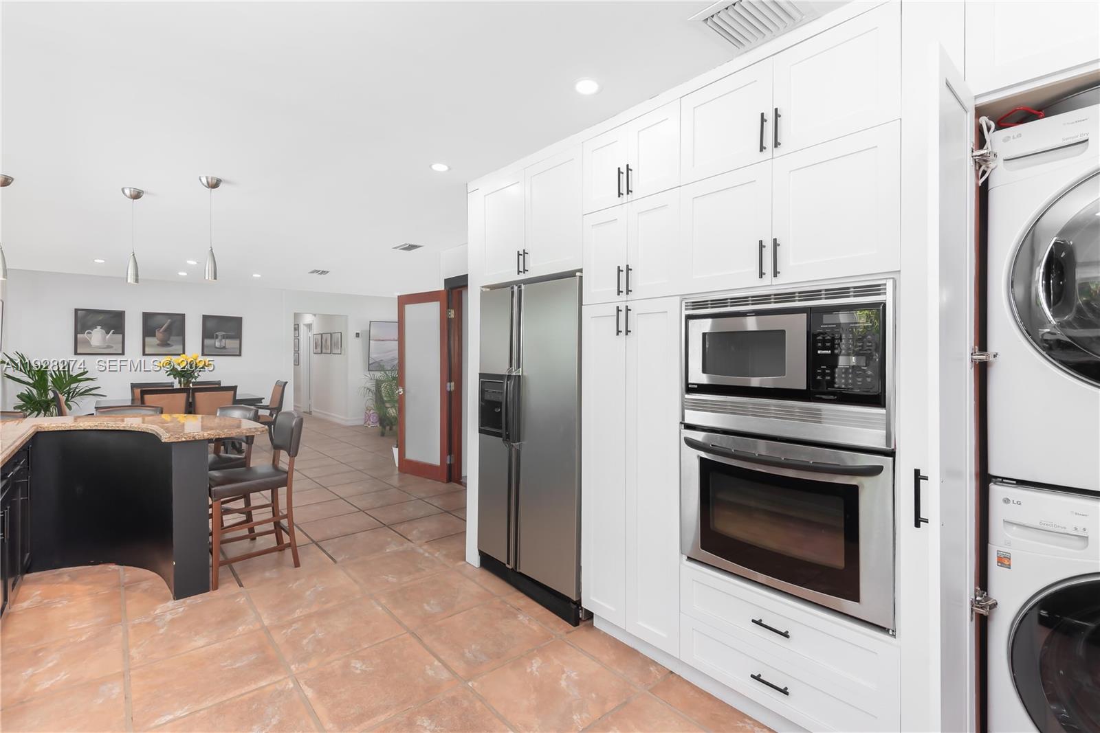 10511 Southwest 122nd Court Miami, FL 33186 - Photo 15 of 36 a kitchen with stainless steel appliances a stove a refrigerator and a fireplace