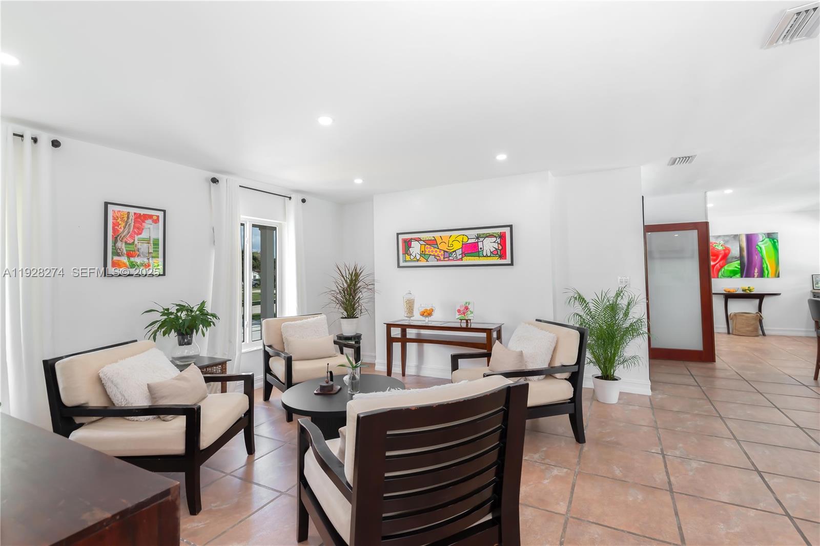 10511 Southwest 122nd Court Miami, FL 33186 - Photo 19 of 36 a living room with furniture and a potted plant