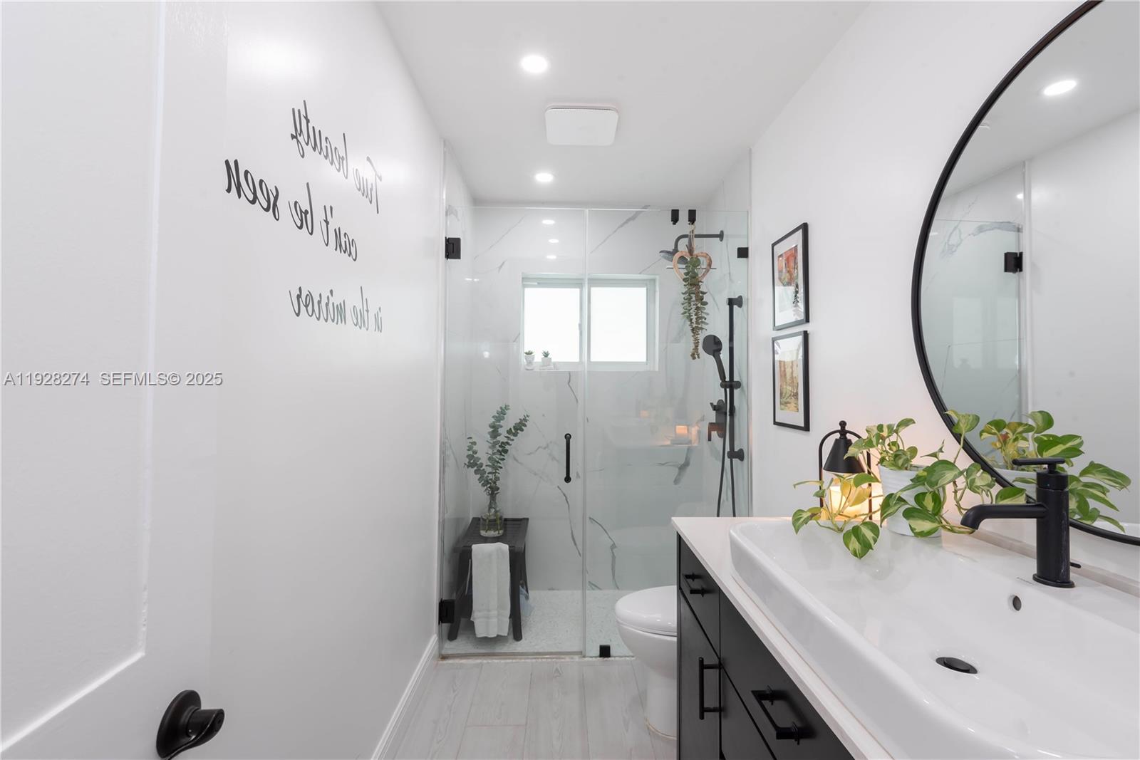 10511 Southwest 122nd Court Miami, FL 33186 - Photo 21 of 36 a bathroom with a sink a mirror and a shower