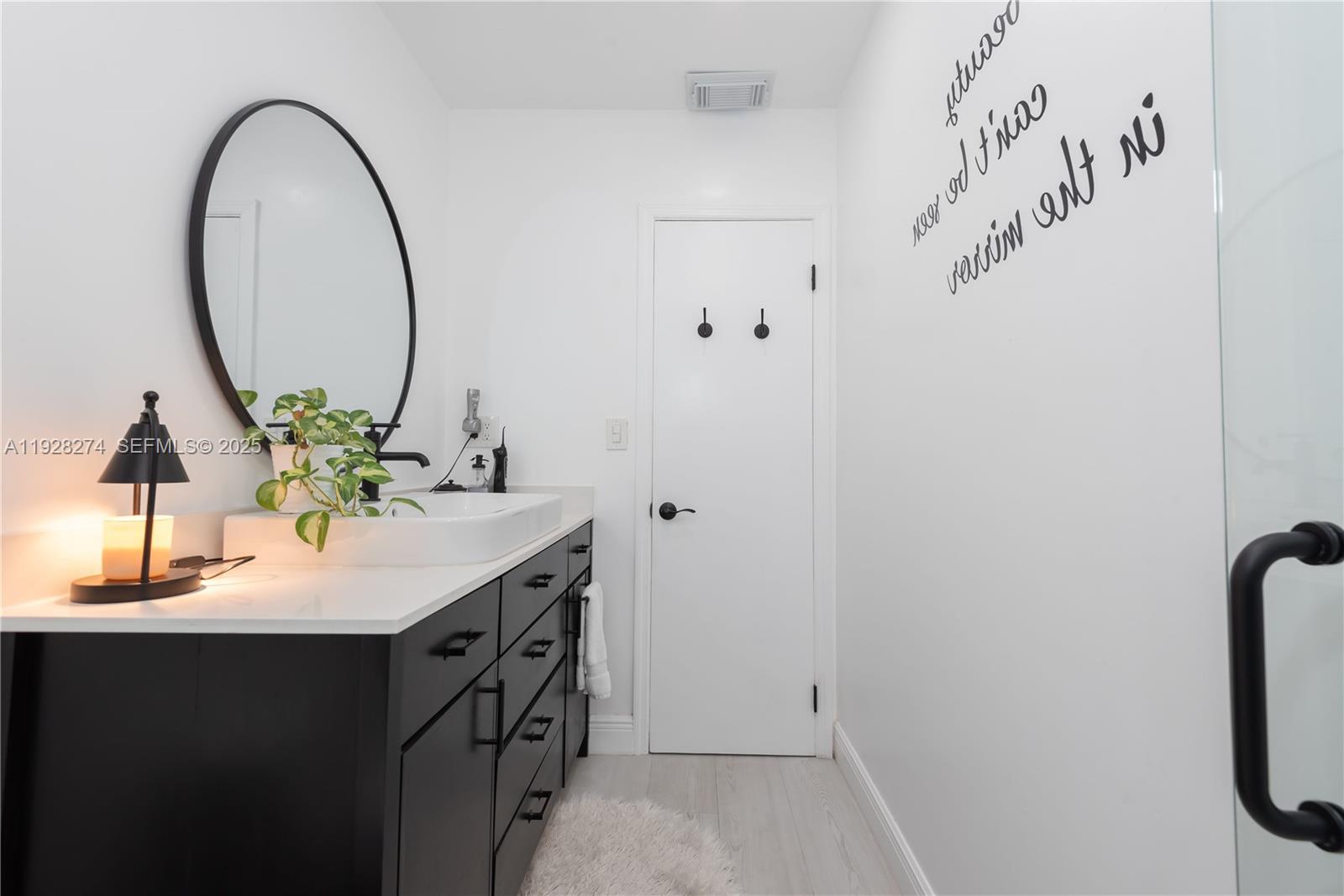 10511 Southwest 122nd Court Miami, FL 33186 - Photo 22 of 36 a bathroom with a sink and a mirror