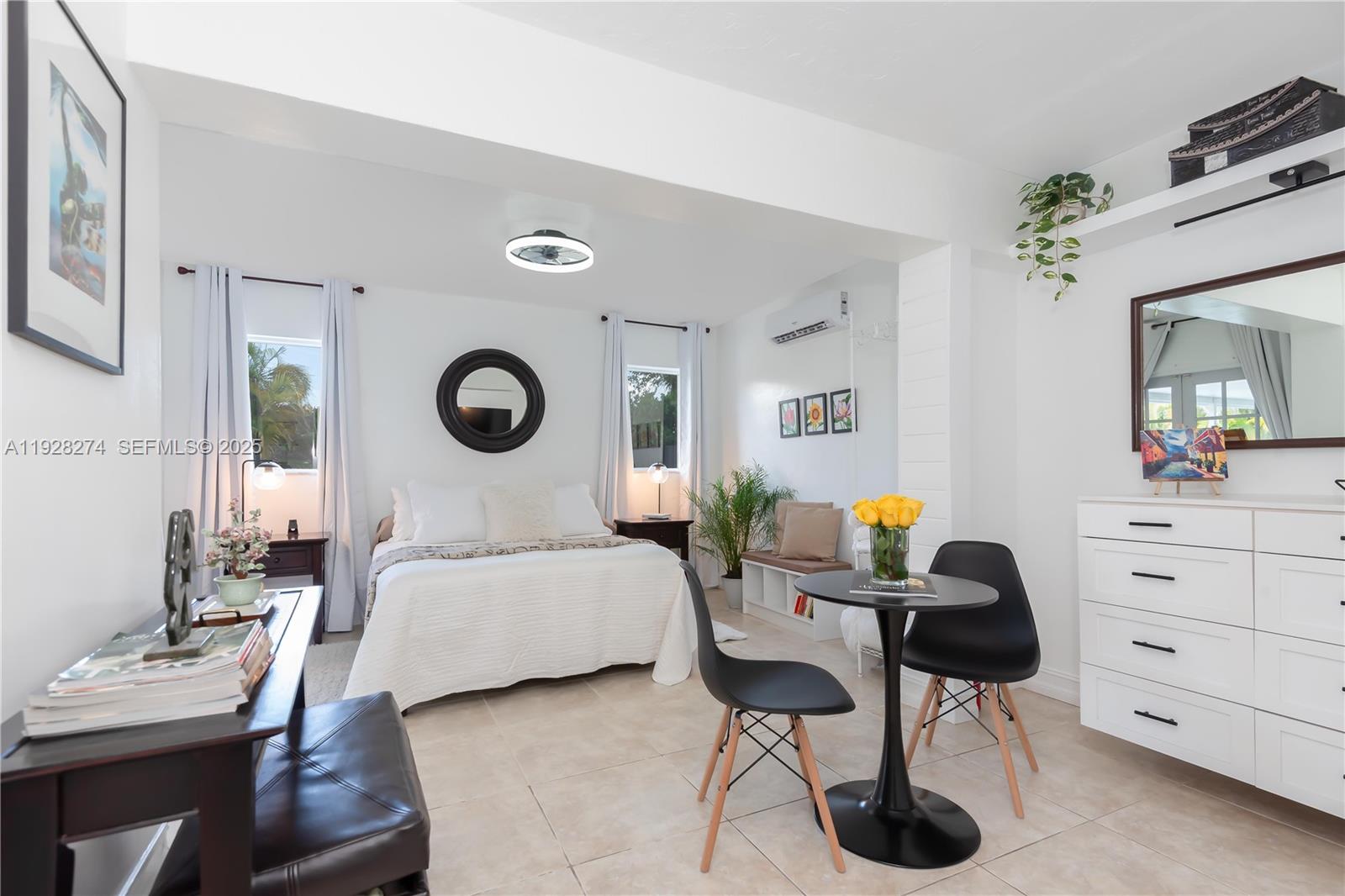 10511 Southwest 122nd Court Miami, FL 33186 - Photo 24 of 36 a living room with furniture a rug and a mirror