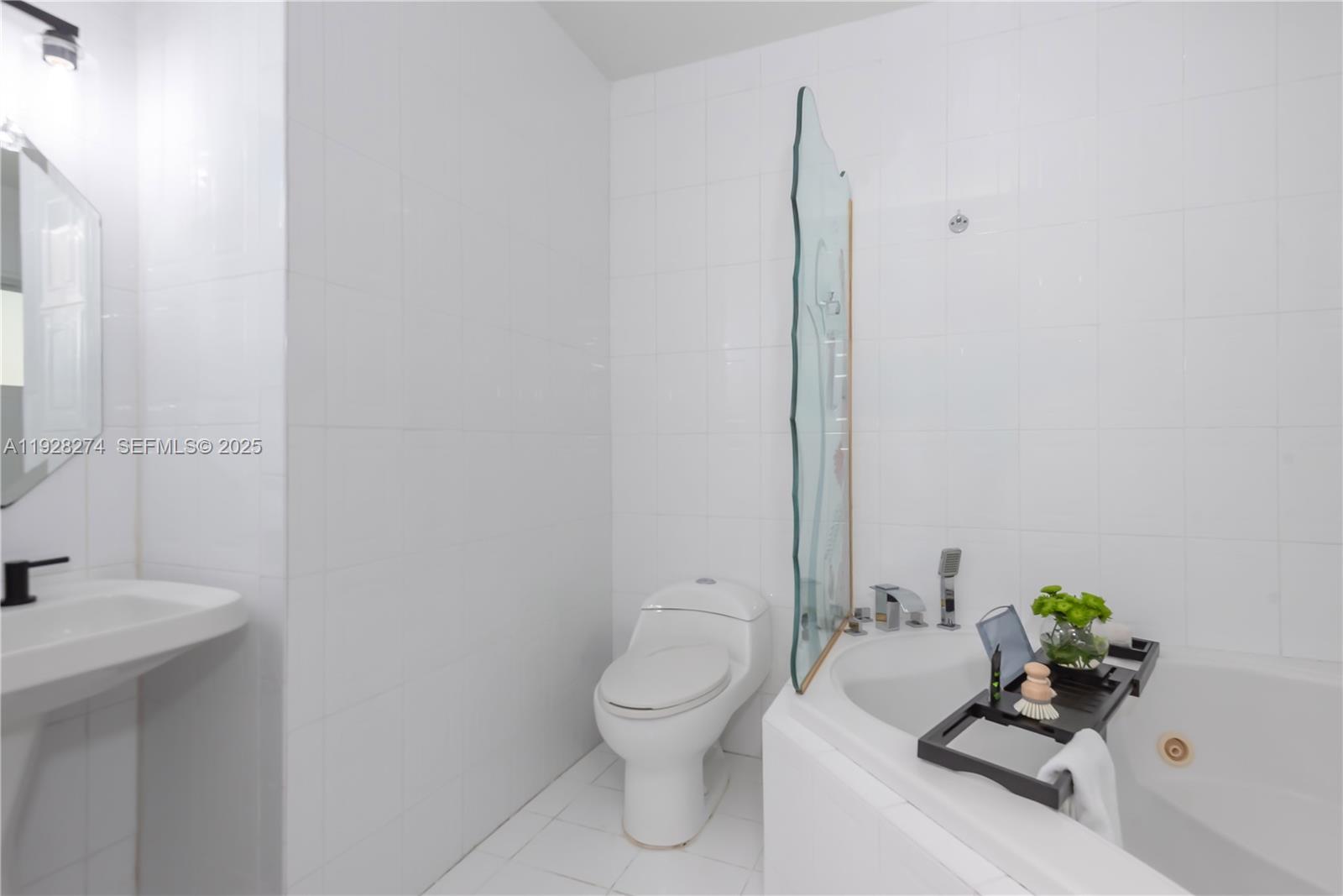 10511 Southwest 122nd Court Miami, FL 33186 - Photo 28 of 36 a bathroom with a toilet a sink and a mirror