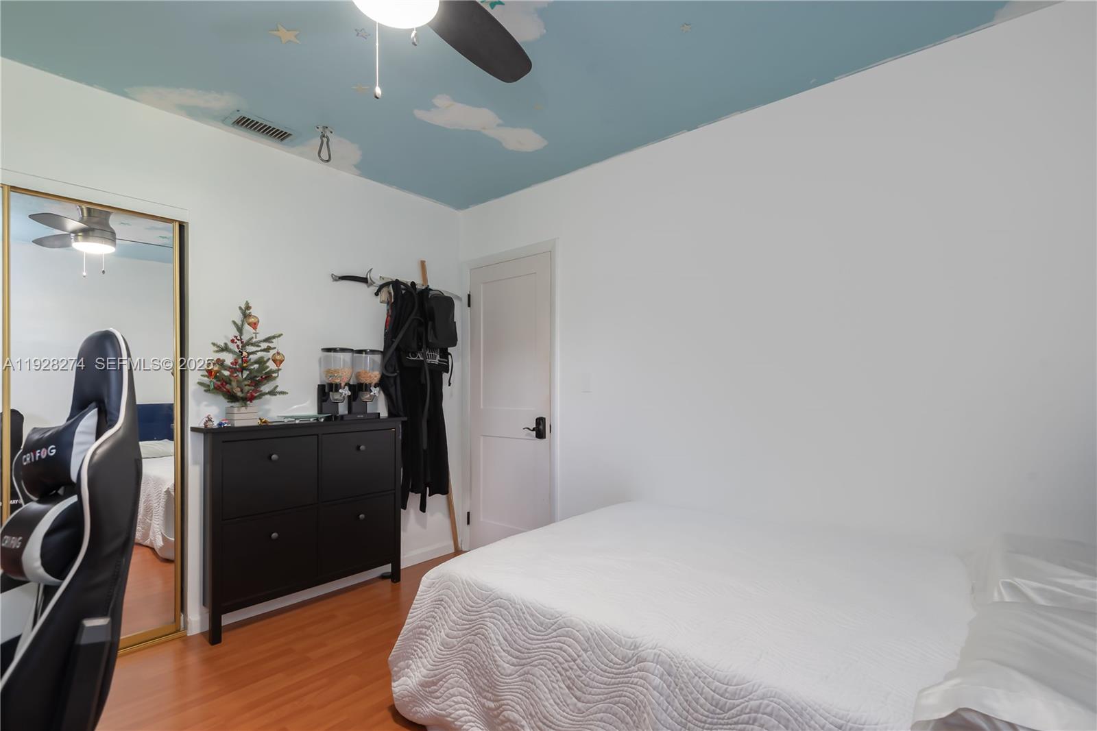 10511 Southwest 122nd Court Miami, FL 33186 - Photo 32 of 36 a bedroom with a bed and cabinets