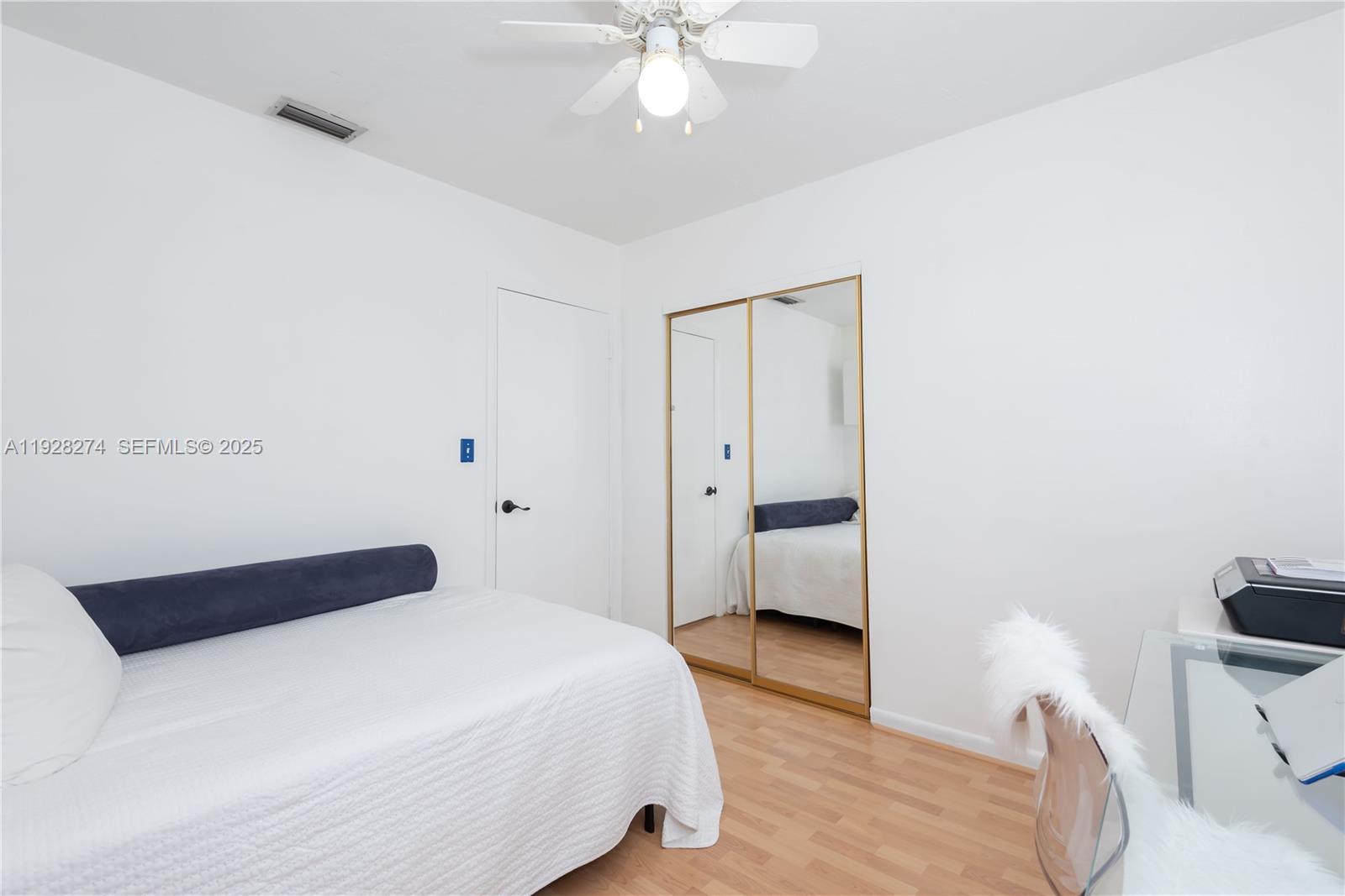 10511 Southwest 122nd Court Miami, FL 33186 - Photo 35 of 36 a bedroom with a bed and a chandelier