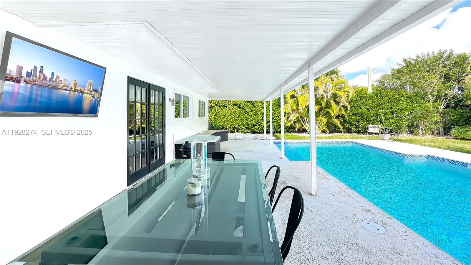 10511 Southwest 122nd Court Miami, FL 33186 - Photo 6 of 36 a living room with furniture and a floor to ceiling window