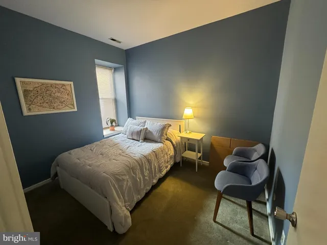 a bedroom with a bed and chair