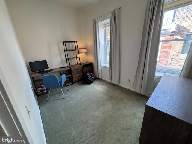 a view of room with workspace and windows