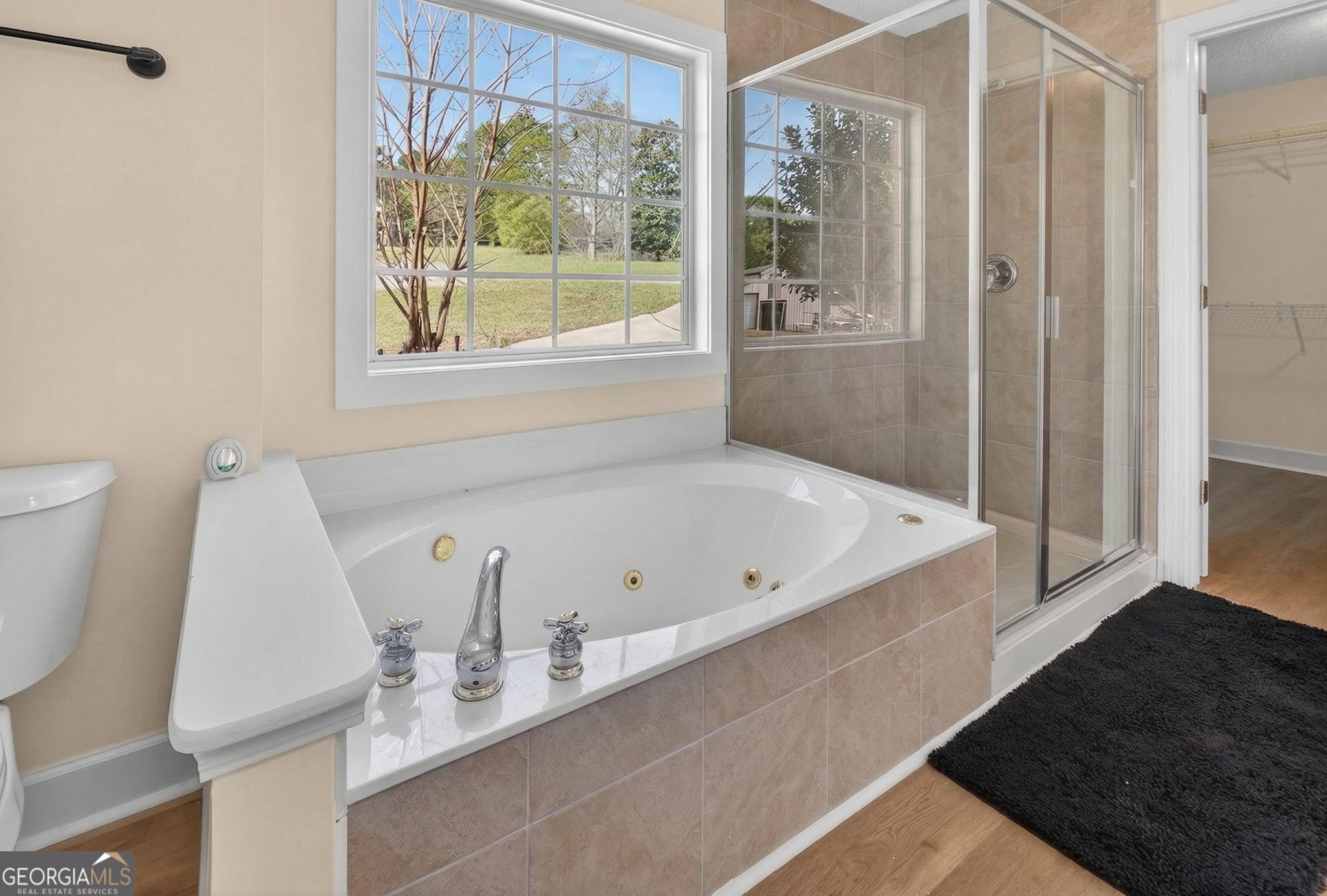 955 Mocassin Gap Road Locust Grove, GA 30248 - Photo 23 of 59 a bathroom with a bathtub and a window