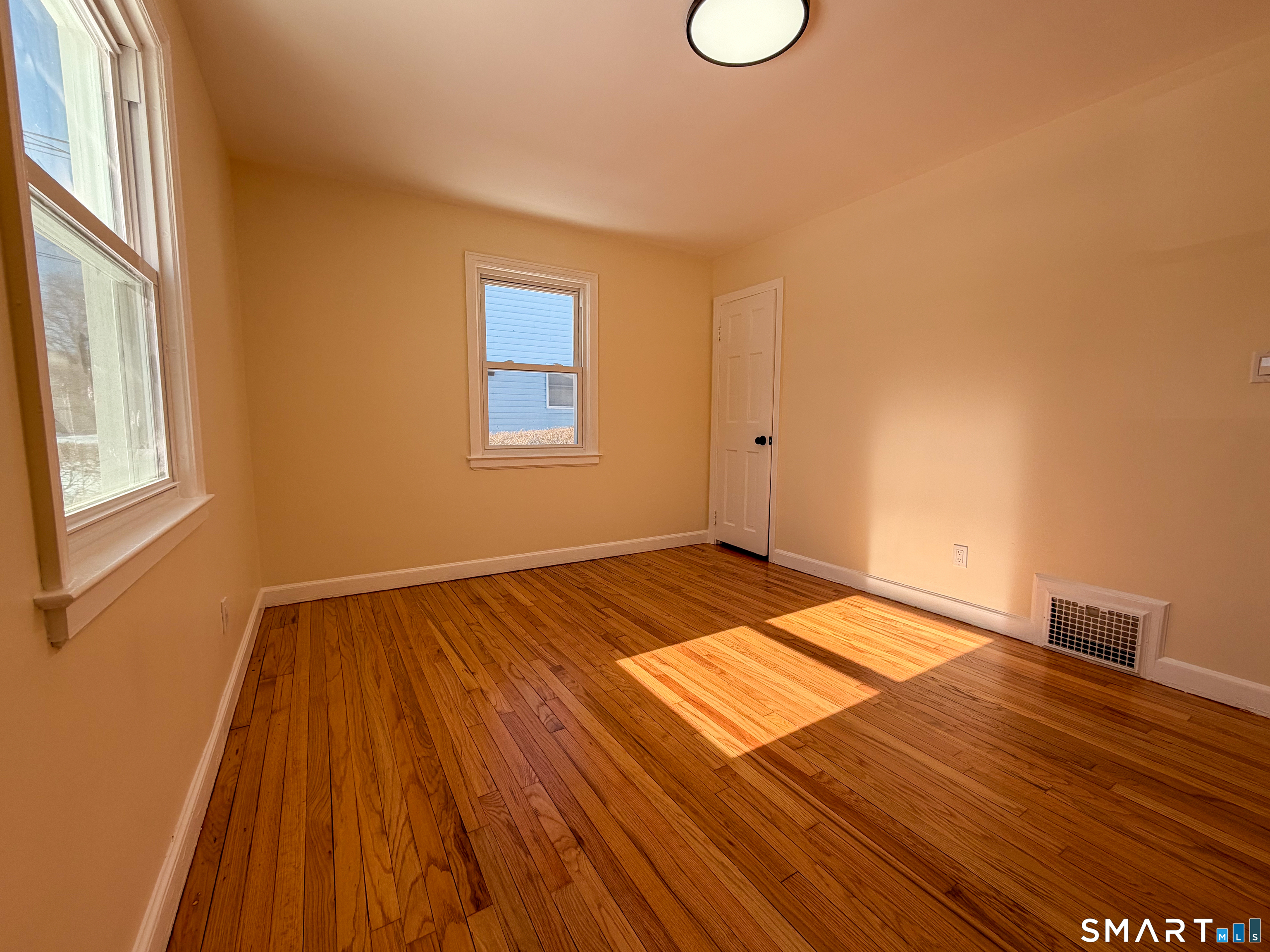 48 Rockwood Road Hamden, CT 06514 - Photo 11 of 17 a view of an empty room with wooden floor and a window