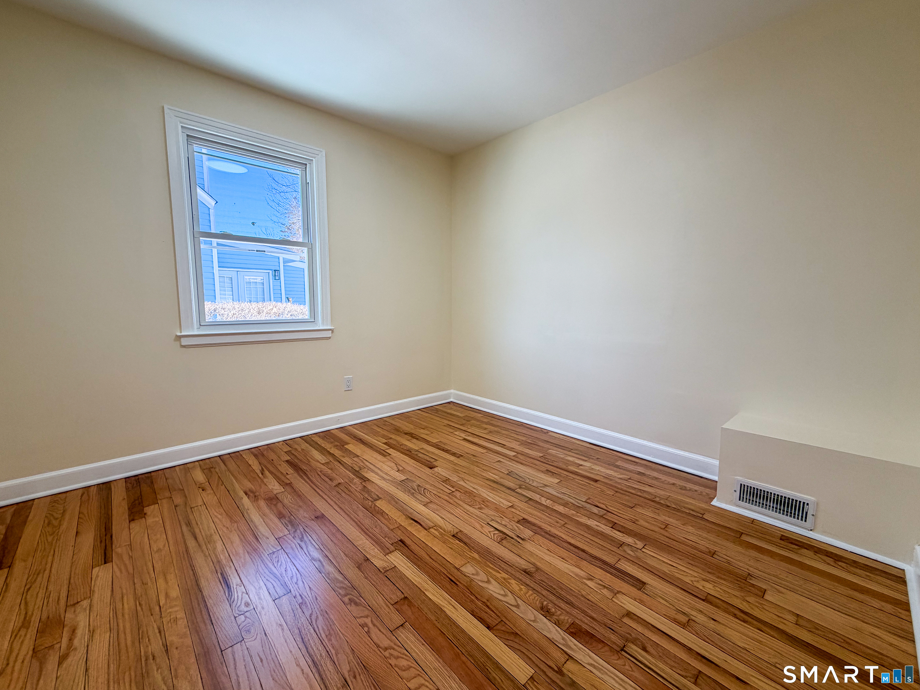 48 Rockwood Road Hamden, CT 06514 - Photo 12 of 17 a view of an empty room with wooden floor and a window