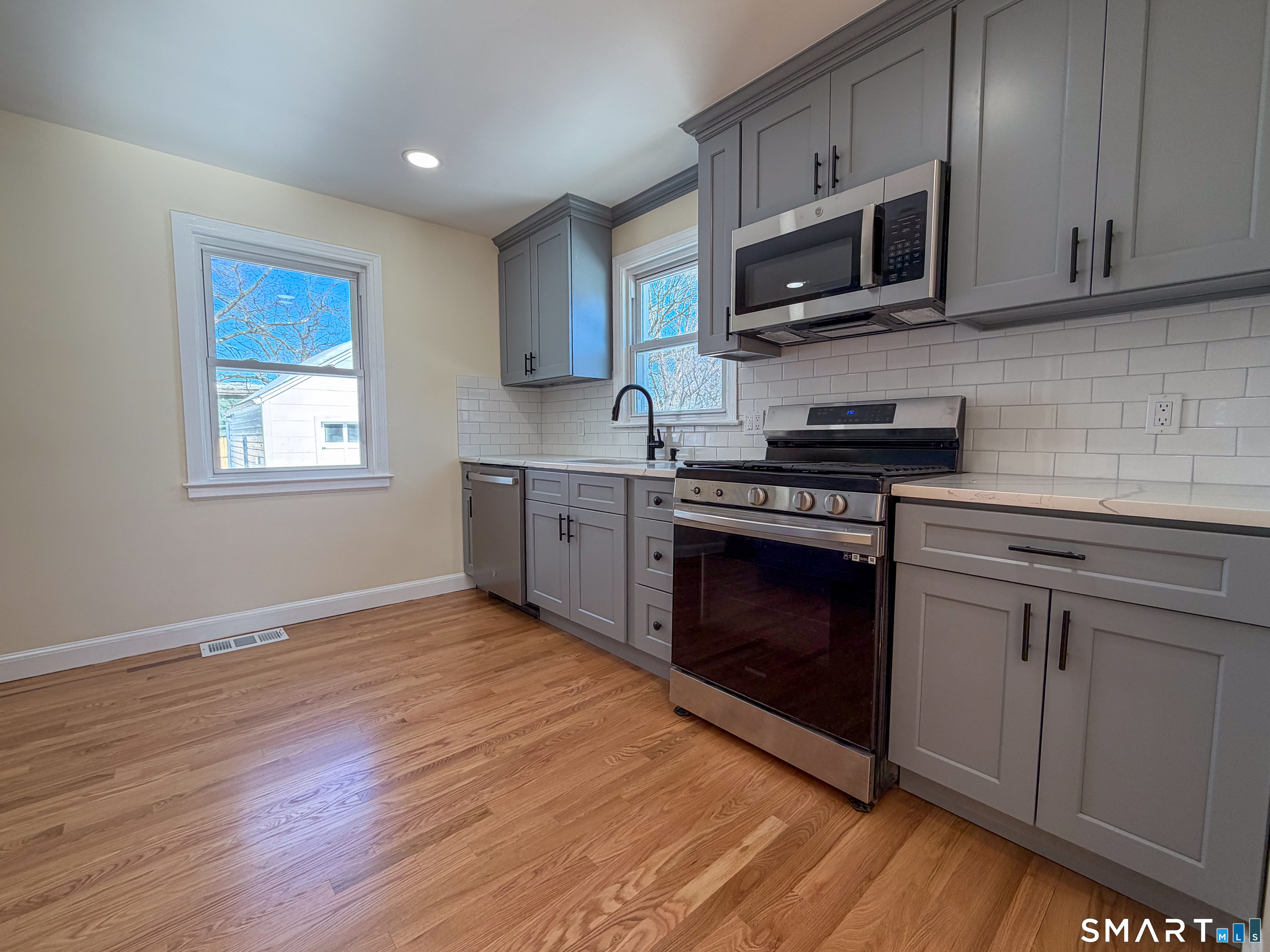 48 Rockwood Road Hamden, CT 06514 - Photo 4 of 17 a kitchen with granite countertop wooden cabinets stainless steel appliances and a window