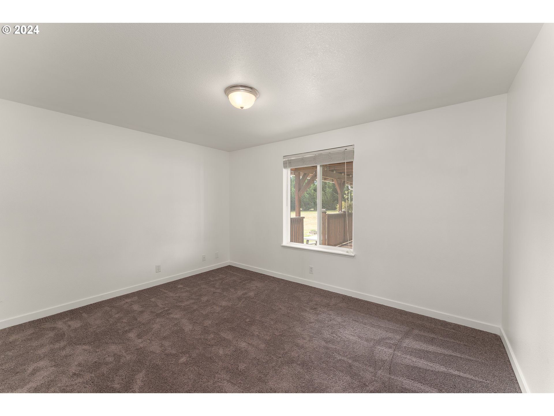 510 Reston Road Tenmile, OR 97481 - Photo 13 of 36 a view of an empty room with a window