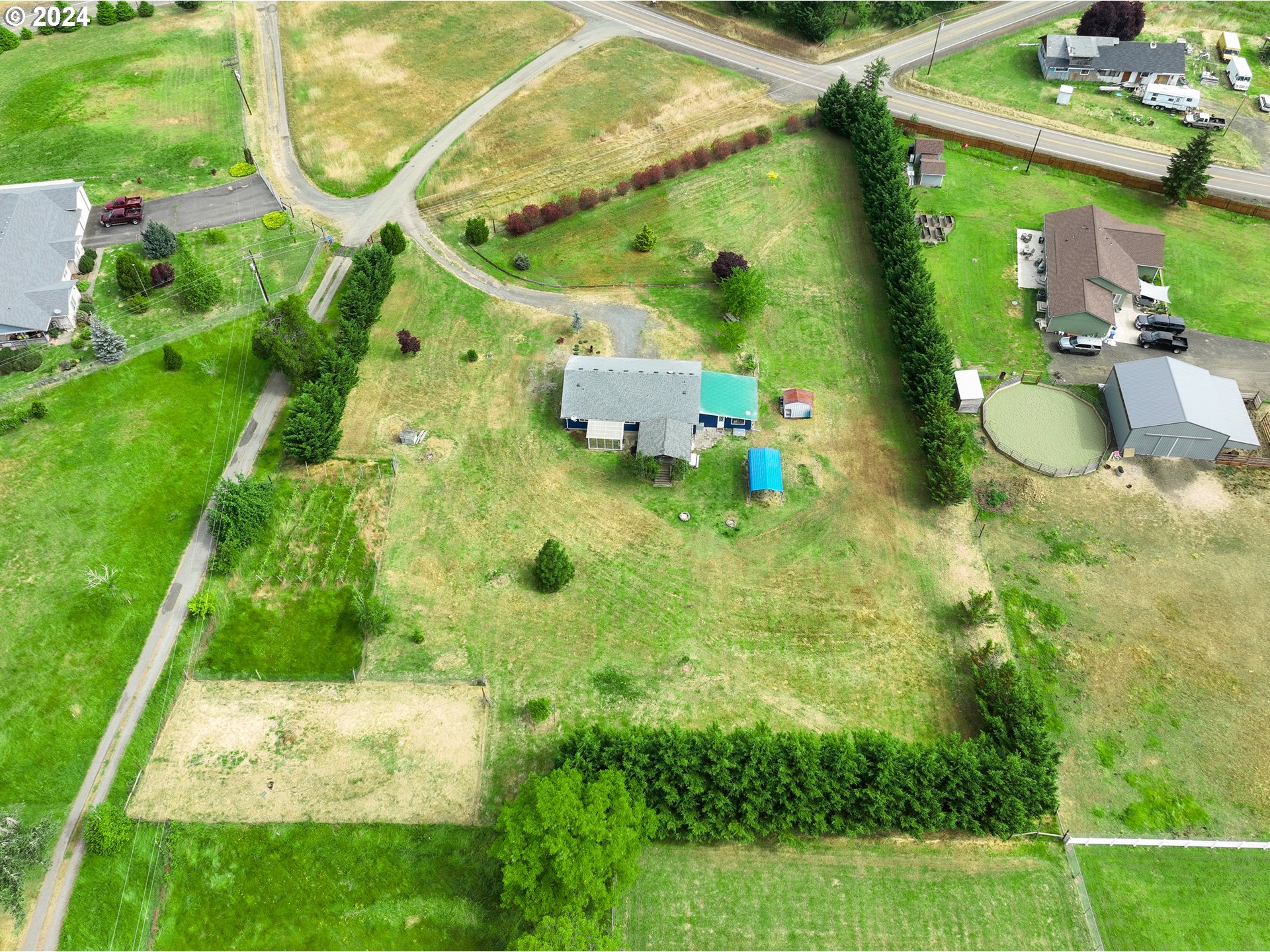 510 Reston Road Tenmile, OR 97481 - Photo 32 of 36 a backyard of a house with lots of green space and plants
