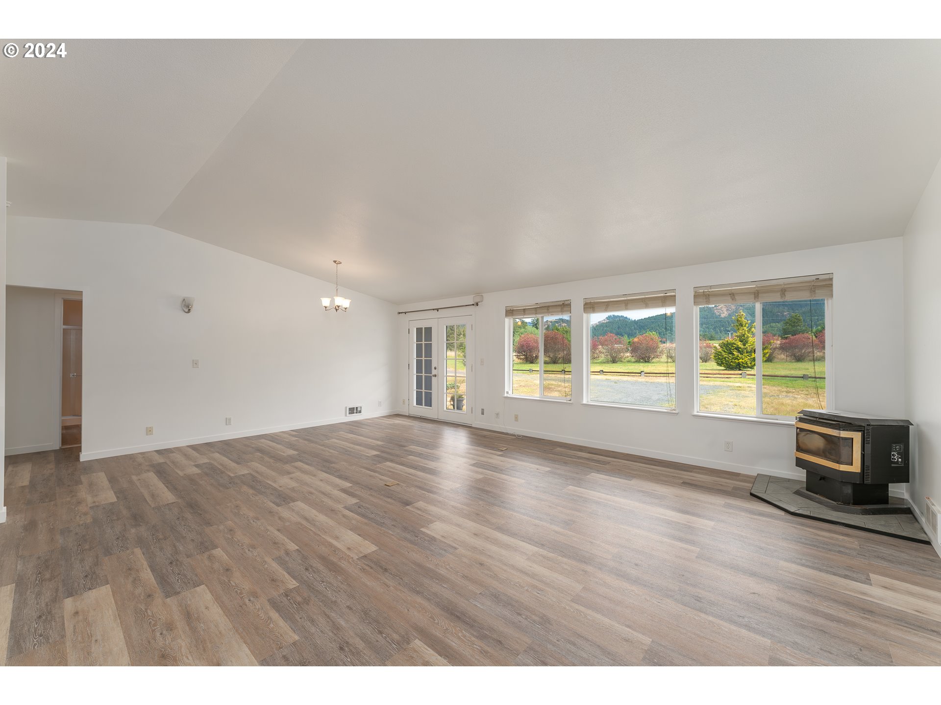 510 Reston Road Tenmile, OR 97481 - Photo 6 of 36 a view of an empty room with wooden floor and a window