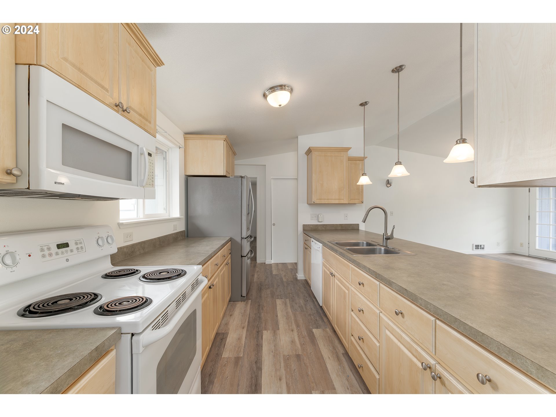 510 Reston Road Tenmile, OR 97481 - Photo 8 of 36 a kitchen with a sink a stove and cabinets