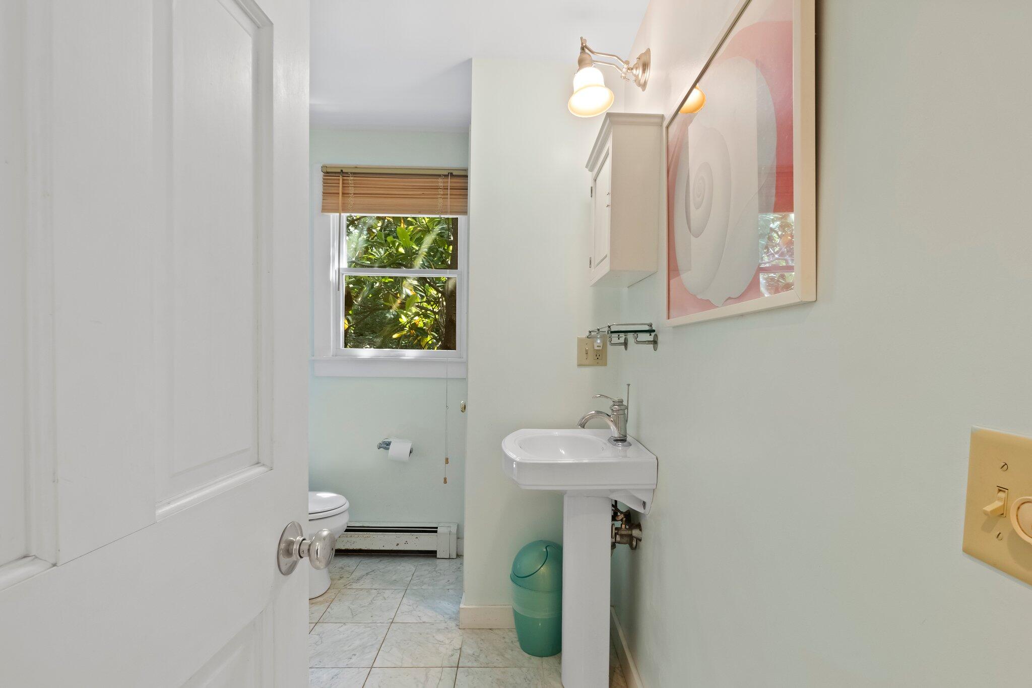 112 Castle Road Truro, MA 02666 - Photo 19 of 43 a bathroom with a toilet sink and mirror
