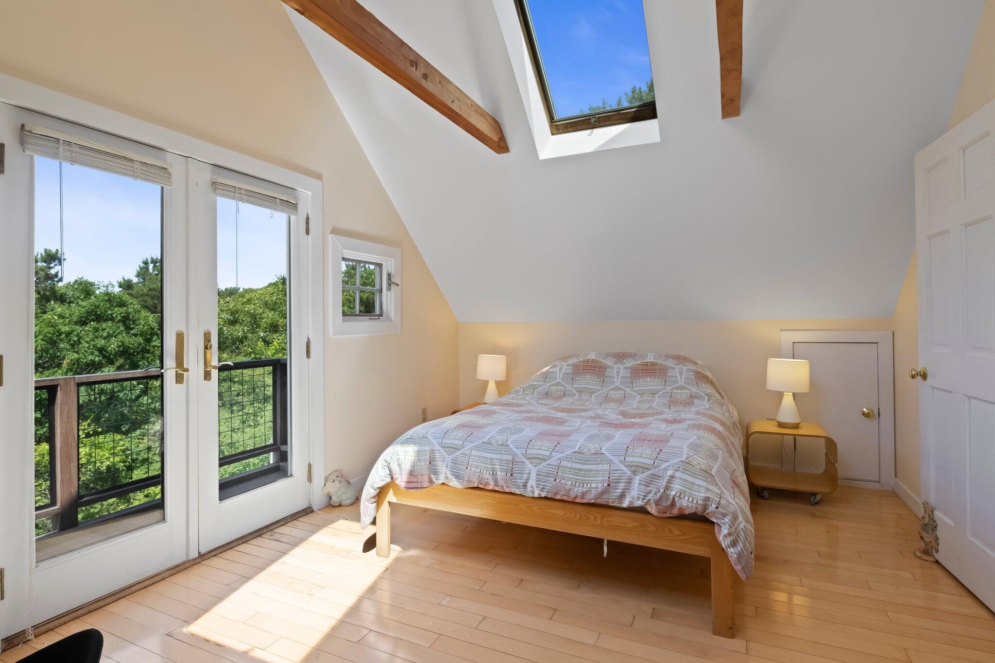 112 Castle Road Truro, MA 02666 - Photo 21 of 43 a bedroom with a bed and wooden floor