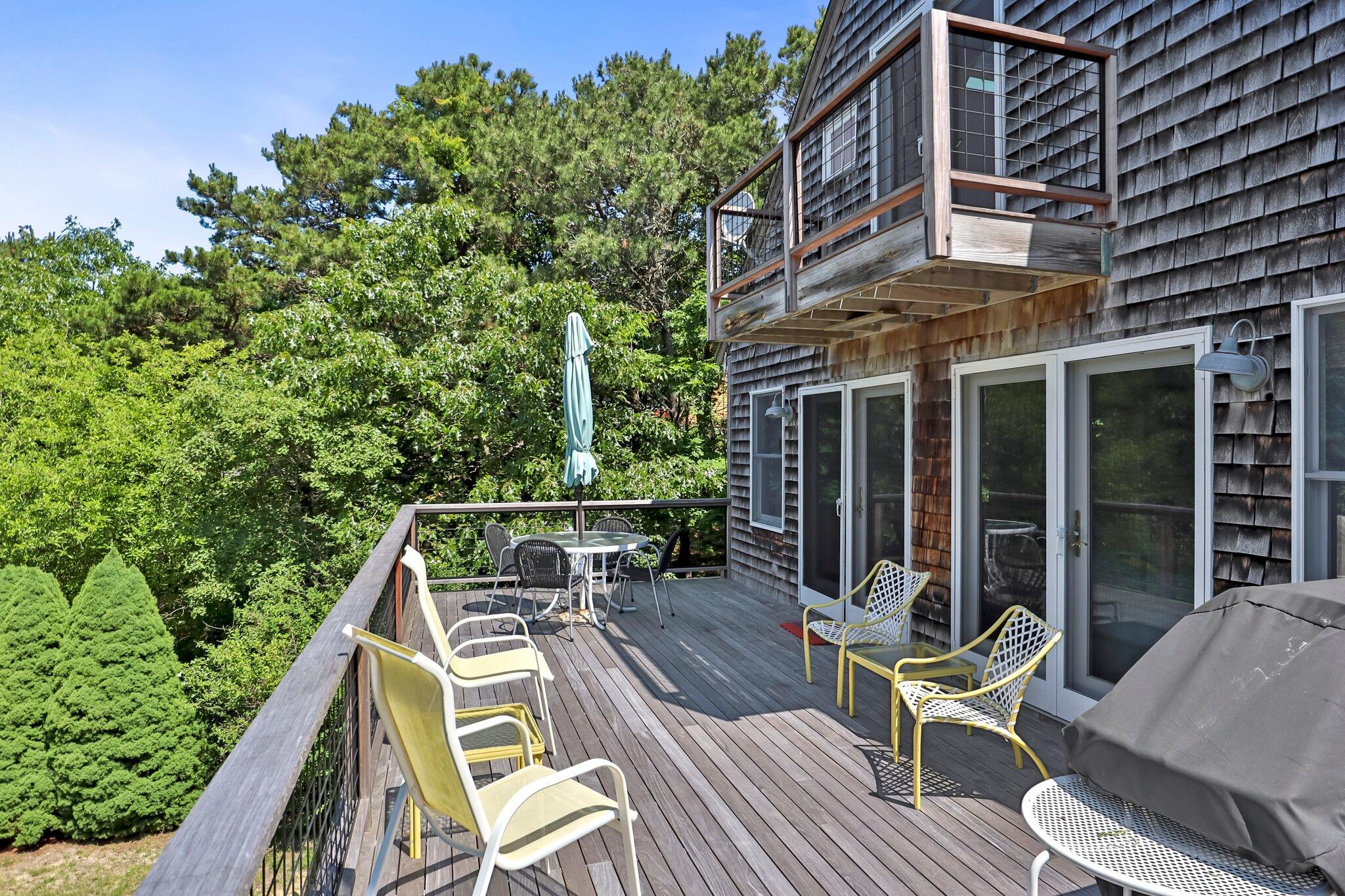 112 Castle Road Truro, MA 02666 - Photo 4 of 43 front view of a house with a chairs and table in a patio