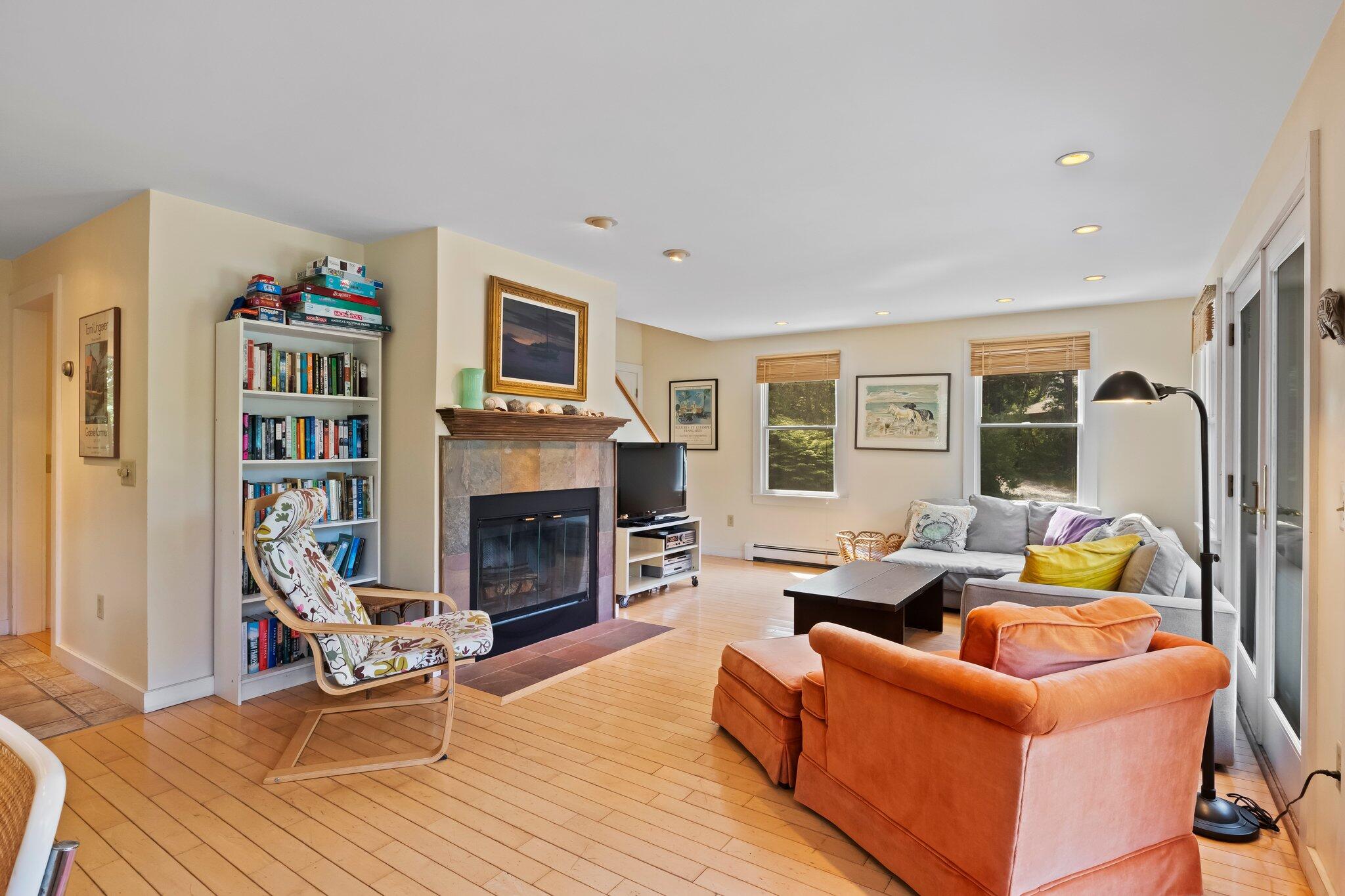 112 Castle Road Truro, MA 02666 - Photo 9 of 43 a living room with furniture a fireplace and a flat screen tv
