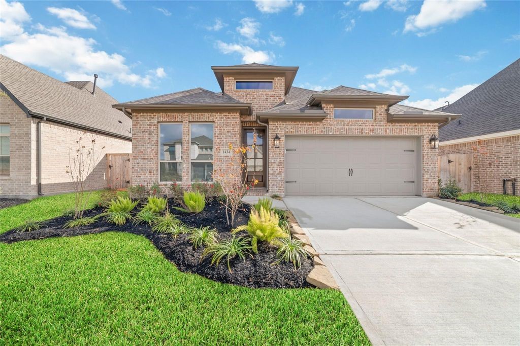 1434 Girasol Street Magnolia, TX 77354 - Photo 1 of 22 a front view of a house with garden