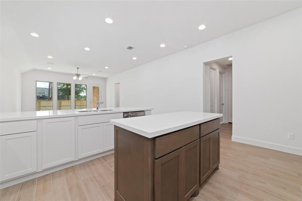 1434 Girasol Street Magnolia, TX 77354 - Photo 15 of 22 a kitchen with a sink and wooden floor