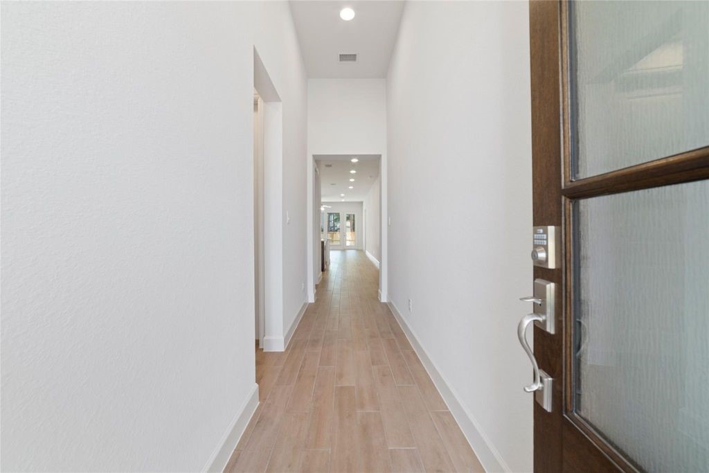 1434 Girasol Street Magnolia, TX 77354 - Photo 5 of 22 a view of a hallway with wooden floor and staircase