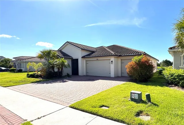 a front view of a house with a yard and garage