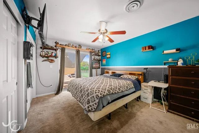 a bed room with a bed mirror and a desk