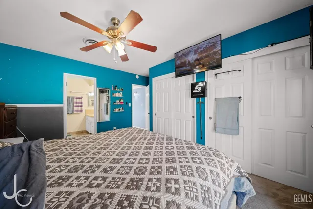 a bedroom with a bed and a refrigerator