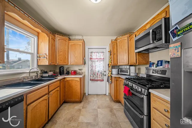 a kitchen with stainless steel appliances a stove sink and cabinets