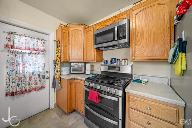 a kitchen with stainless steel appliances granite countertop a stove and a microwave