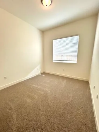 a bathroom with a granite countertop sink toilet a mirror and shower