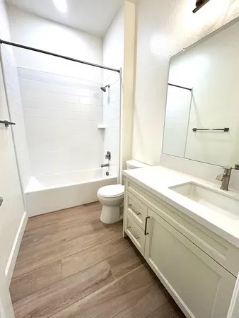 a kitchen with a sink cabinets and wooden floor