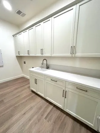 a view of a kitchen with wooden floor