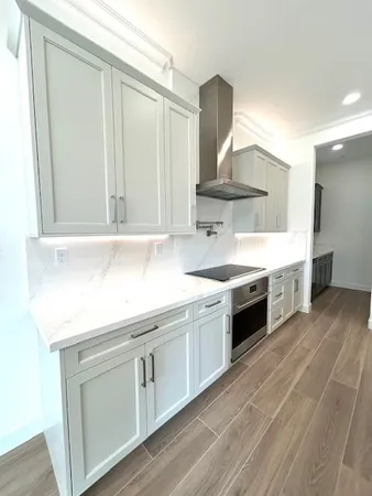 a kitchen with stainless steel appliances a sink and cabinets