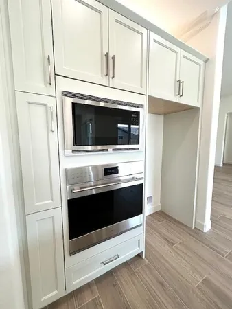 a kitchen with stainless steel appliances a stove microwave and refrigerator