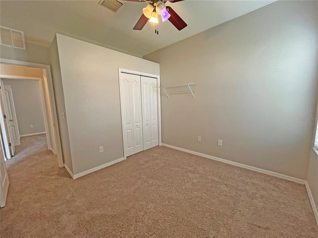 24925 Vintage Court Lutz, FL 33559 - Photo 24 of 38 an empty room with a ceiling fan and window